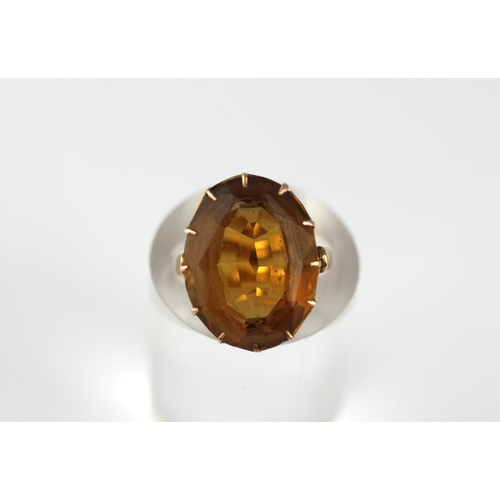 168 - A gold ring claw set with an oval cut citrine, unmarked, size H ½,  gross weight 6.6g... 