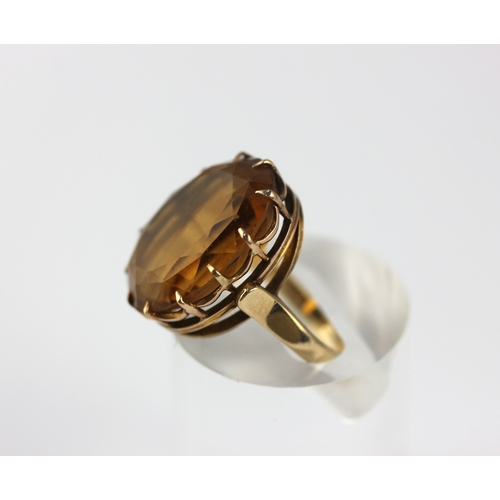 168 - A gold ring claw set with an oval cut citrine, unmarked, size H ½,  gross weight 6.6g... 