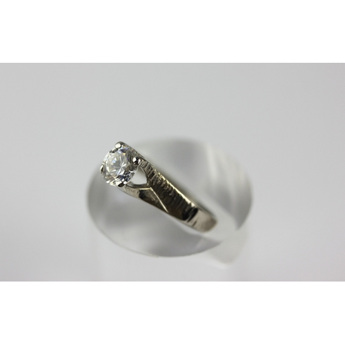 17 - A 9ct white gold and synthetic colourless gem set solitaire ring with decorated shoulders, size M, g... 