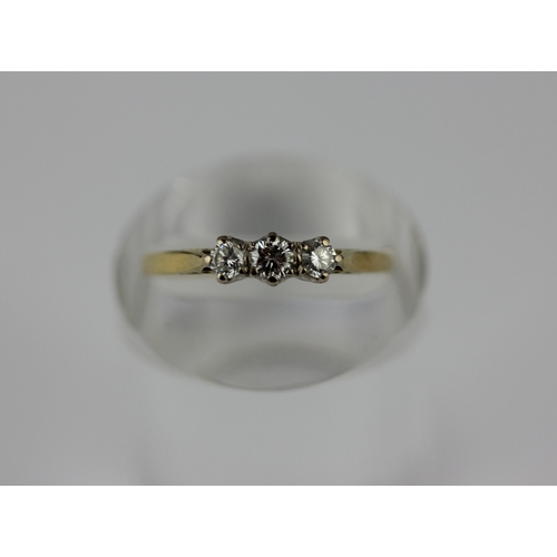 174 - An 18ct gold and diamond three stone ring claw set with a row of circular cut diamonds, ring size P ... 
