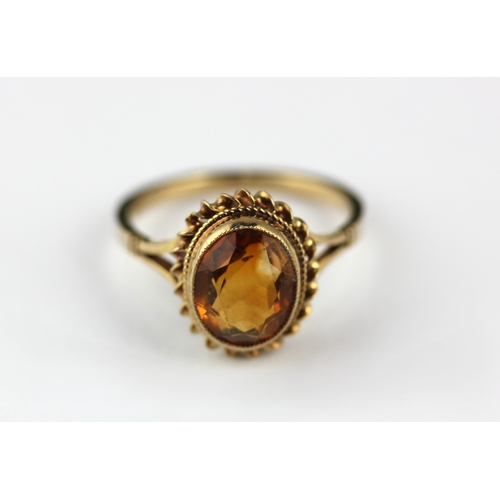 175 - A 9ct gold ring, collet set with an oval cut citrine, size 0 and ½, gross weight 2.8g... 
