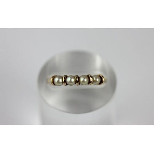 19 - A 9ct gold ring mounted with a row of cultured pearls size N and a half, gross weight 1.3g  ... 
