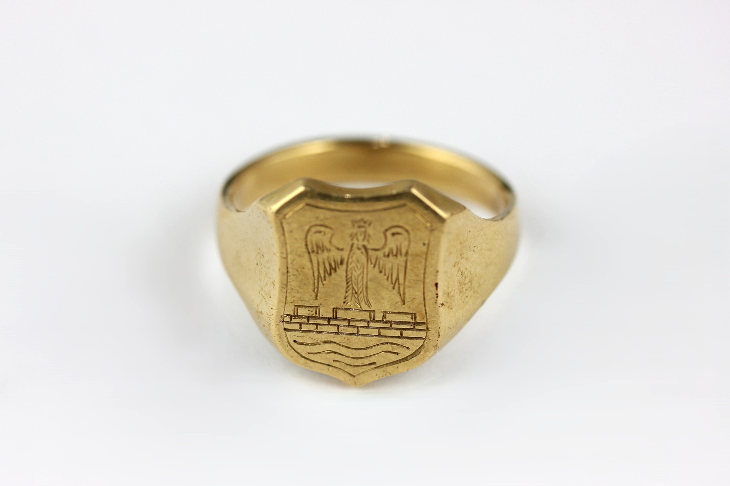 A gentleman's gold shield shaped signet style ring engraved with a ...
