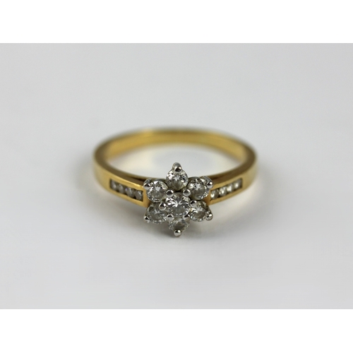 22 - An 18ct gold and diamond seven stone cluster ring with diamond set four stone shoulders size R and a... 