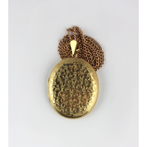 23 - A 9ct gold oval pendant locket with floral engraved decoration on a curb linked neck chain with a bo... 
