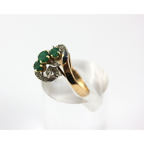 3 - A gold ring set with three circular cut emeralds and with small diamonds, detailed 14k 585, size N ½... 