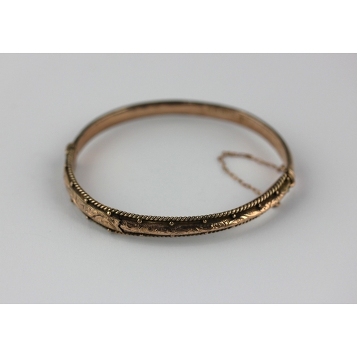 30 -  A 9ct gold oval hinged bangle with beaded and rope twist decorated sides, Birmingham 1903, gross we... 