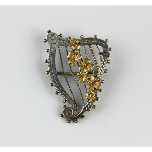 31 - A silver and gilt brooch designed as a harp with a flower spray, weight 3g ... 