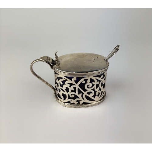 343 - An Edwardian pierced silver mustard pot, makers marks rubbed, Birmingham, 1904, with blue glass line... 
