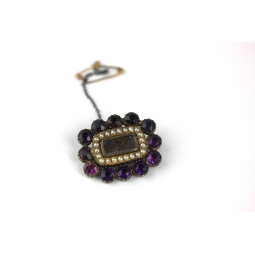 36 - A Georgian gold and silver set amethyst paste and half pearl brooch glazed with a central hair locke... 
