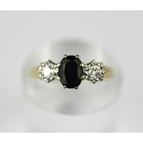 38 - A 18ct gold sapphire and diamond three stone ring claw set with the oval cut sapphire at the centre ... 