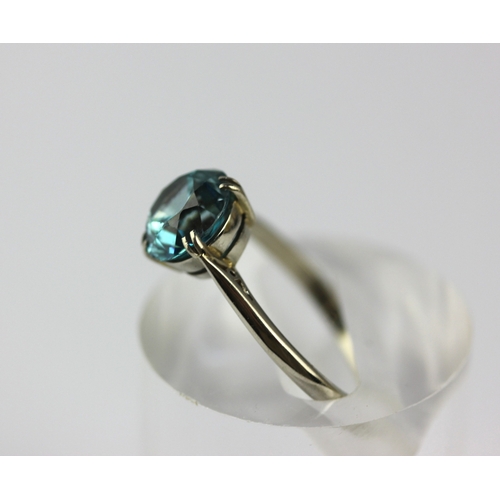 41 - A white gold ring claw set with a circular cut blue zircon, detailed 9ct, size M, gross weight 2g ... 