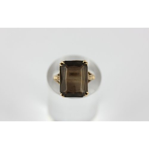 44 - A 9ct gold ring claw set with a cut corned rectangular smoky quartz ring size K and half, gross weig... 