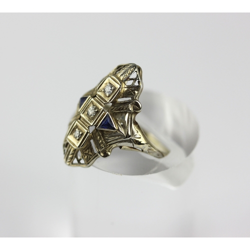 52 - A diamond and synthetic sapphire set panel shaped ring, set with three circular cut diamonds, size M... 