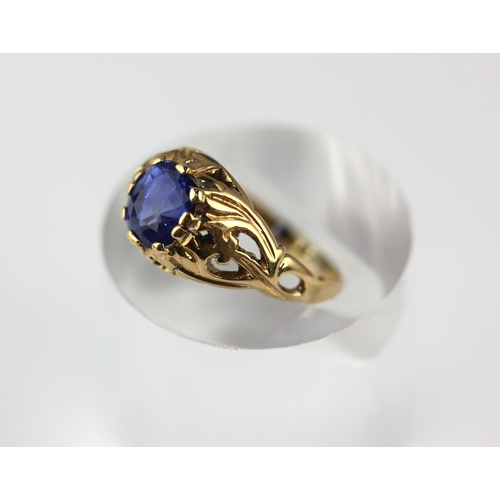 53 - A gold ring, claw set with an oval cut sapphire with pierced decoration, unmarked, size K, gross wei... 