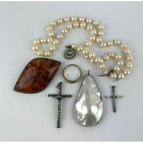 59 - A single row necklace of uniformed cultured pearls the clasp detailed 835, a reconstituted amber bro... 