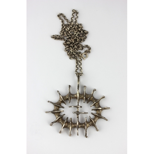 8 - A silver pendant of abstract design with a silver circular link, neck chain weight 2.6g... 