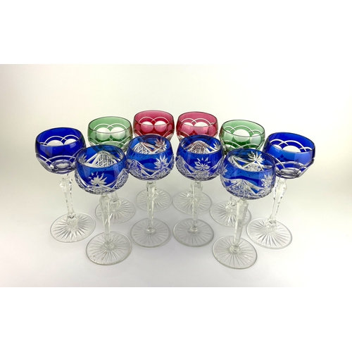 105 - A harlequin group of ten Bohemian colour flashed cut glass wine glasses on tall stems, comprising a ... 