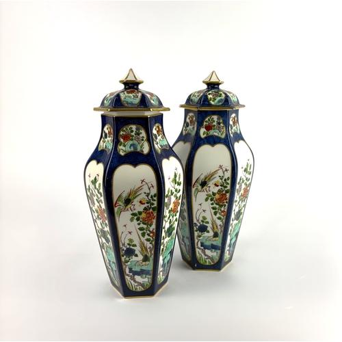 136 - A pair of porcelain vases with covers painted with coloured enamels in the Chinese taste with gilt e... 