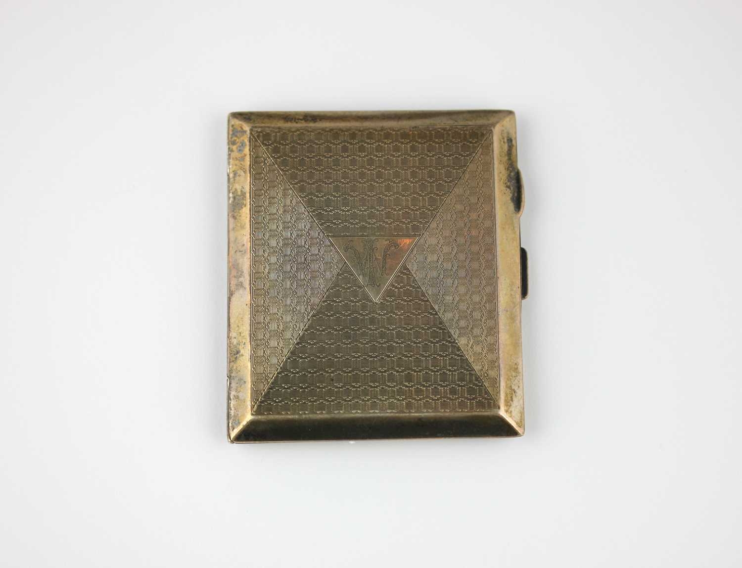 A silver rectangular cigarette case with engine turned decoration ...