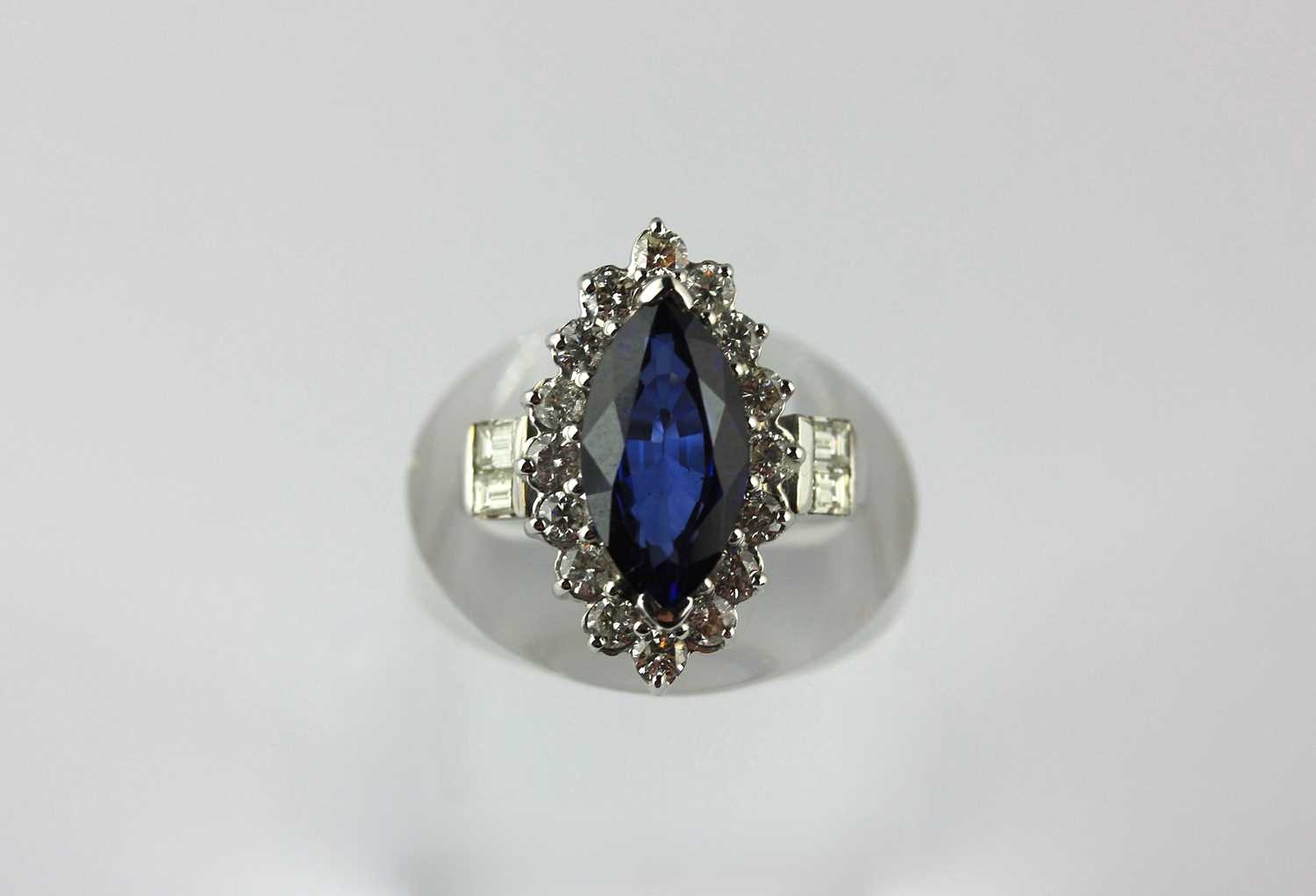 A white gold, synthetic sapphire and diamond marquise-shaped cluster ...