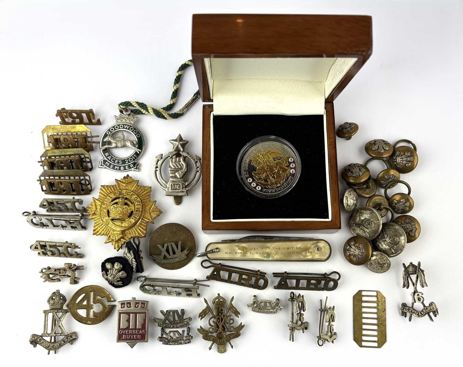 A group of badges and buttons, mostly relating to Indian army units, a ...