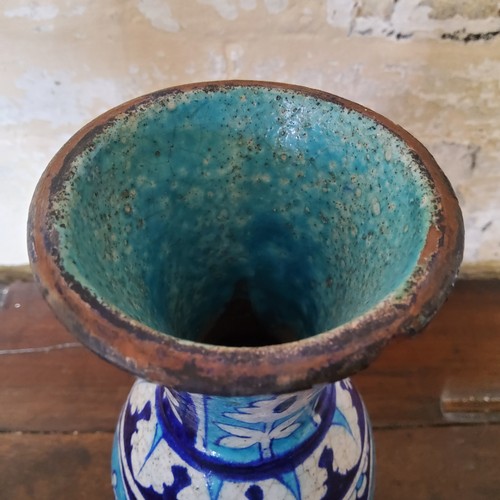 6 - A large Persian Isnik pottery baluster shaped vase decorated in turquoise and cobalt blue panels wit... 