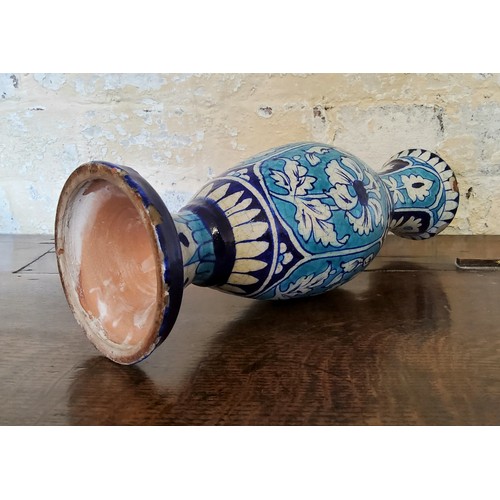 6 - A large Persian Isnik pottery baluster shaped vase decorated in turquoise and cobalt blue panels wit... 
