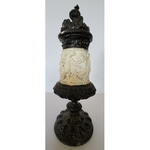 27 - An unusual Victorian chalk pedestal urn and cover, the urn deocrated in relief with cherubs, the cov... 