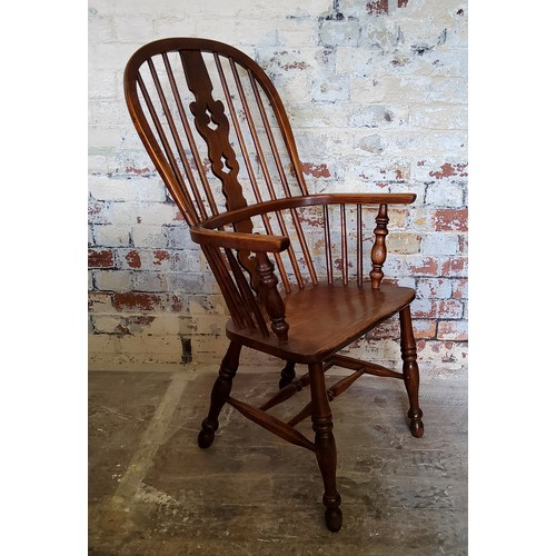 42 - A 19th century elm Windsor arm chair, 105cm H x 58cm W x 43cm D