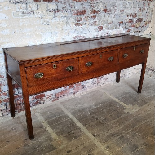 45 - An 18th century country house oak dresser base,well figured, holding three long drawers to frieze, s... 