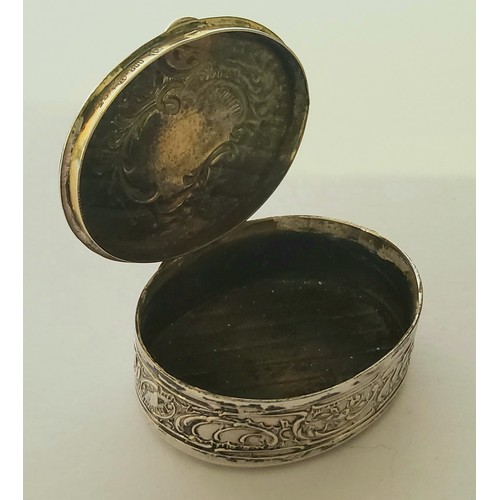 100 - A German silver late 19th/20th century snuff/pill box, moulded in relief with scolls, vacant cartouc... 