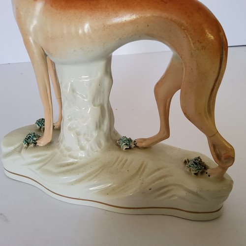 118 - A Victorian Staffordshire greyhound holding a hare c.1860; A Victorian Staffordshire flat back spill... 