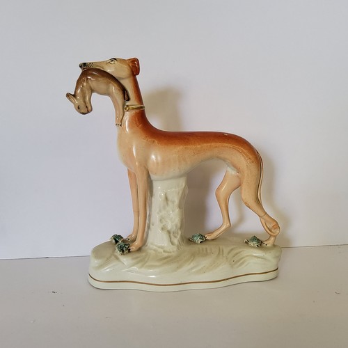 118 - A Victorian Staffordshire greyhound holding a hare c.1860; A Victorian Staffordshire flat back spill... 