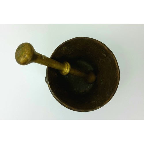 176 - A solid bronze pestle and mortar, decorated with coat of arms, 12cm diameter x 11cm high