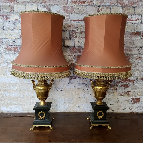 195 - A handsome pair of large twin handled urnular parcel gilt and Belgian black marble table lamps raise... 