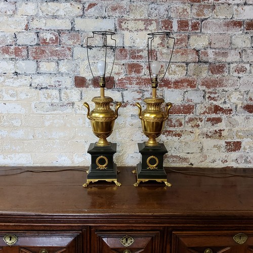195 - A handsome pair of large twin handled urnular parcel gilt and Belgian black marble table lamps raise... 