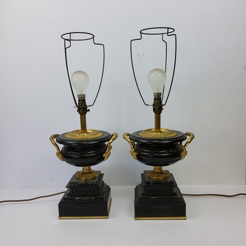 196 - A bold pair of Empire style gilt metal mounted marble table lamps, squatted twin handled urnular bod... 