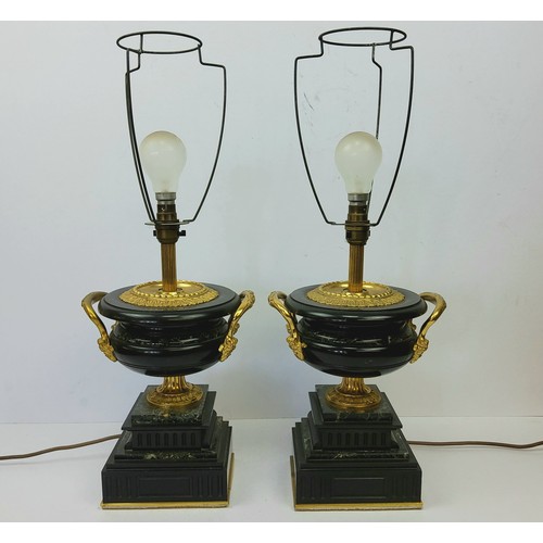 196 - A bold pair of Empire style gilt metal mounted marble table lamps, squatted twin handled urnular bod... 