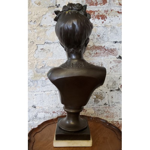 203 - A French pedestal bronze bust of a young woman with roses in her hair, raised on carrara marble base... 