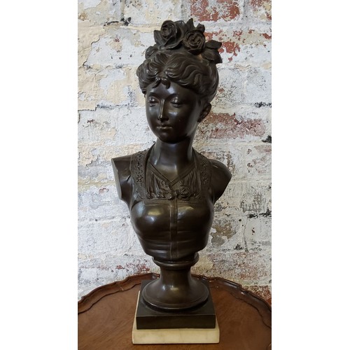 203 - A French pedestal bronze bust of a young woman with roses in her hair, raised on carrara marble base... 