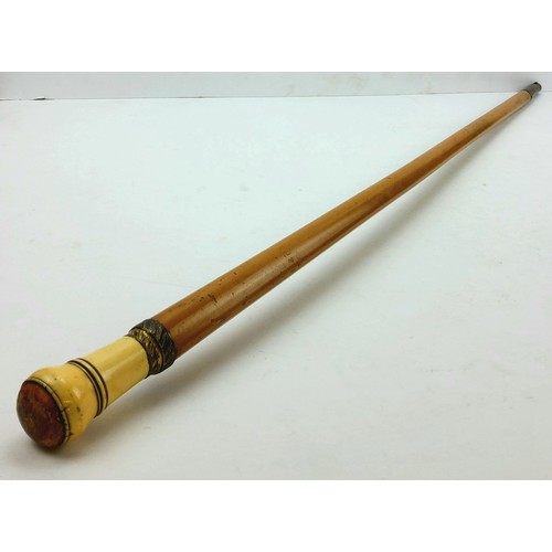 214 - A Victorian ivory walking cane inset with butterscotch amber handle with palmwood shaft 107cm high