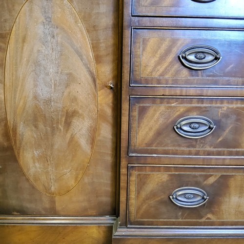 226 - A Regency Revival flamed mahogany breakfront library bookcase, oversailing cornice above three glaze... 