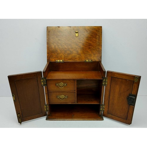 237 - A late Victorian well figured oak table top smoking cabinet, the hinged top and press moulded cupboa... 