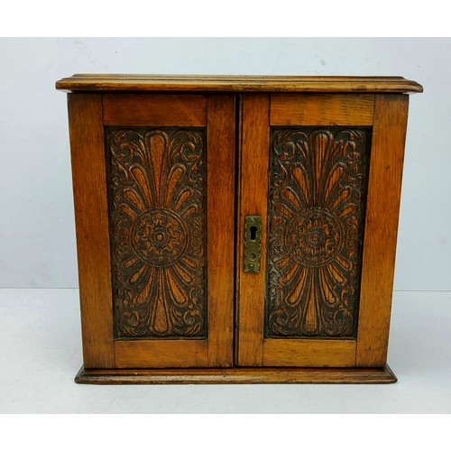 237 - A late Victorian well figured oak table top smoking cabinet, the hinged top and press moulded cupboa... 