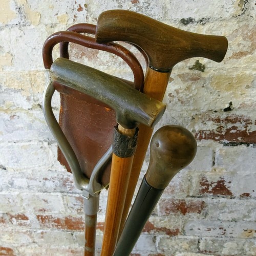 240 - A mid 20th century copper umbrella stand in the form of a household cavalry boot with ceremonial bra... 