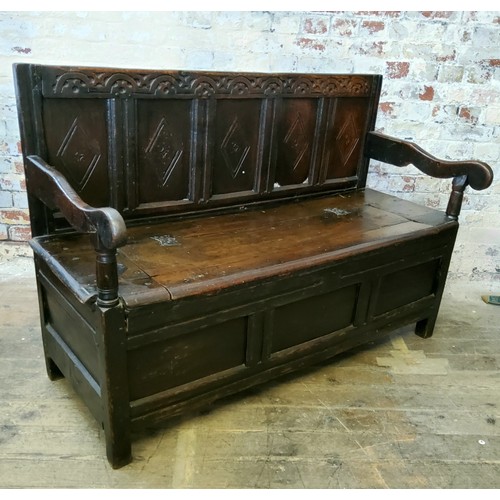 242 - A 17th century carved oak five panel backed box seat settle, with iron bound hinged seat and open sc... 