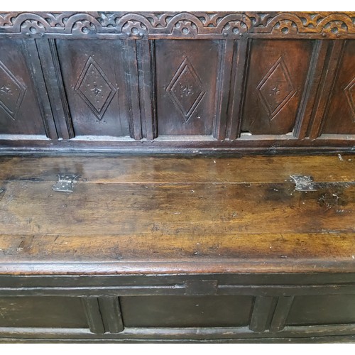 242 - A 17th century carved oak five panel backed box seat settle, with iron bound hinged seat and open sc... 