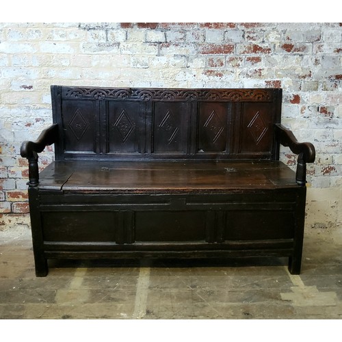 242 - A 17th century carved oak five panel backed box seat settle, with iron bound hinged seat and open sc... 