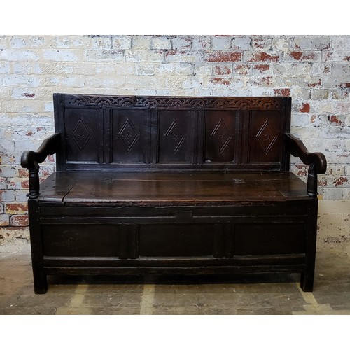 242 - A 17th century carved oak five panel backed box seat settle, with iron bound hinged seat and open sc... 